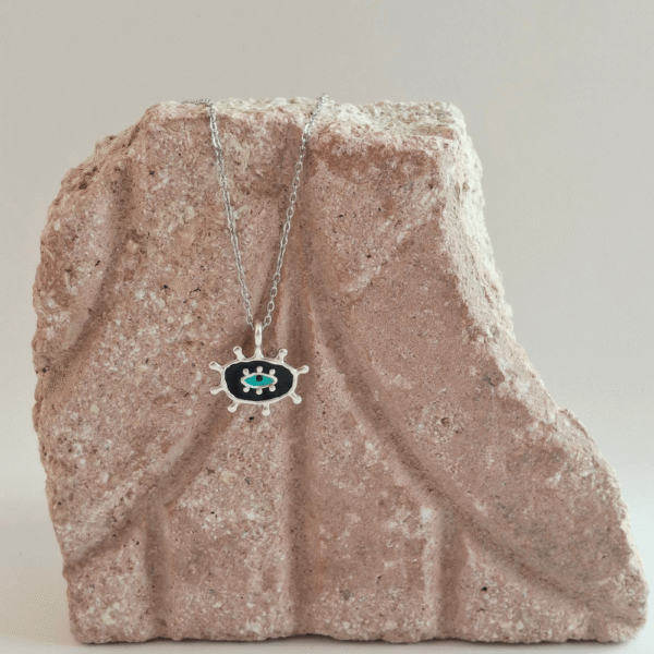 Kολιέ με μαύρη βάση και τιρκουάζ λεπτομέρεια, εμπνευσμένο από το σύμβολο του ματιού